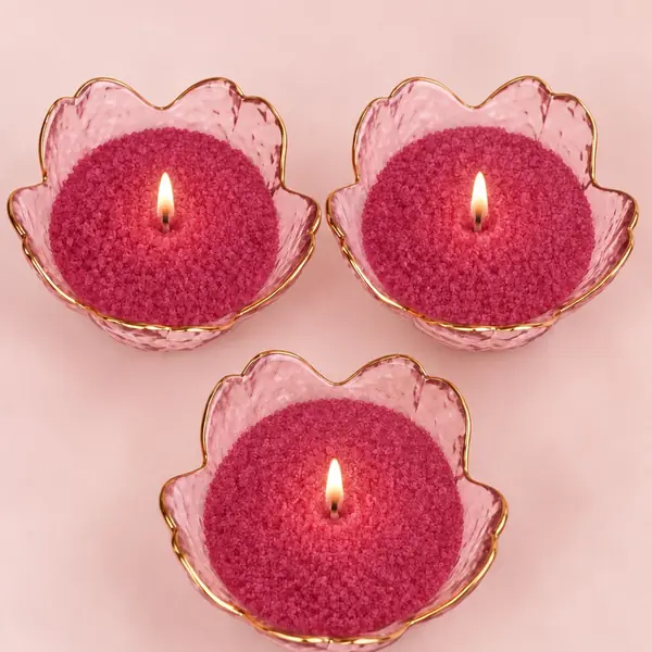 Pink sand wax candles in glass bowls